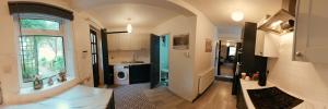 a kitchen with a sink and a washing machine at King St Cosy - wood stove & ice maker in Loughborough