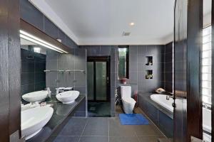 a bathroom with two sinks and two toilets at Mandala by Villacarte in Bang Tao Beach +22 photos
