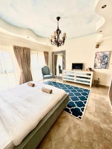 a large bedroom with a large bed and a chandelier at DARÏ in Dubai