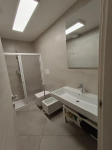a bathroom with a sink and a toilet and a mirror at Casa Bonelli 37 in Barletta +31 photos