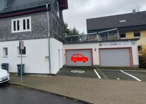 a garage with a car painted on the side of it at Kinderklinik 600m zum Bahnhof 2A in Siegen
