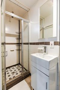 a bathroom with a sink and a shower at Apartment 1720: East Village in New York