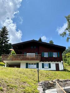 a house with a balcony on top of a hill at Chalet Tobeleck - CharmingStay in Flumserberg
