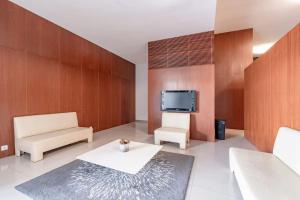 a living room with a couch and a tv at Porto Stadium Quality Studio w/ garage spot in Porto