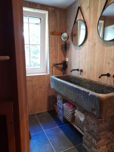 a bathroom with a stone sink and a window at Tante Hanna in Winterberg