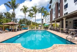 a pool at a hotel with chairs and umbrellas at Hampton Inn & Suites Wellington in Wellington