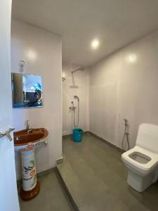 a bathroom with a toilet and a sink at Omkar Beach Bungalow in Agonda