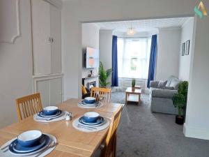 a kitchen and living room with a table and chairs at St Bernard House TSAC in Stockton-on-Tees