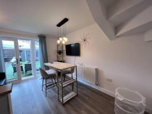 a kitchen with a table and chairs in a room at Luxury 10 Bed Palace w/ Parking in Birmingham