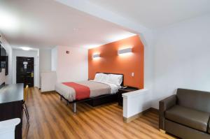 a small room with a bed and a couch at Motel 6 Moss Point, MS in Moss Point