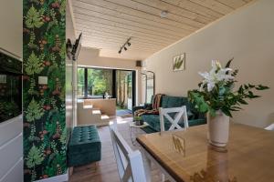 a living room with a table and a couch at Domek Tatary Odkryj Zakopane in Zakopane