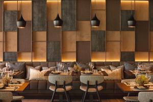 a restaurant with tables and chairs and a couch at Ikos Porto Petro in Portopetro