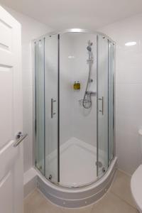 a shower with a glass door in a bathroom at Pandora Hotel in St. Peter Port