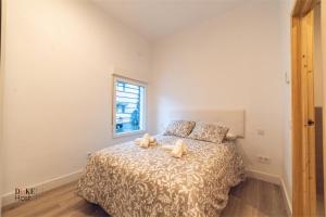 um quarto com uma cama com dois bichos de peluche em 5Torres Apartment em Madrid
