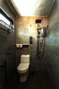 a bathroom with a toilet and a shower in it at Rumah Satu by NK in Alor Setar