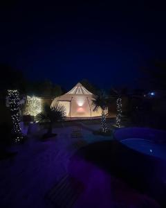 a lit up tent at night with christmas lights at Bubble Glamping Sicily in Catania