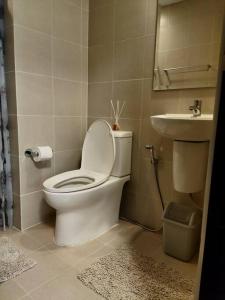 La salle de bains est pourvue de toilettes et d'un lavabo. dans l'établissement Cozy studio w/ Nintendo Switch, à Bacolod