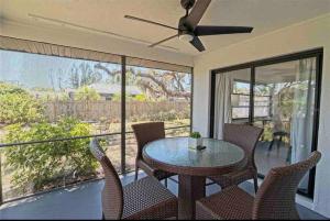 a dining room with a table and chairs on a balcony at Shamrock Park, Legacy Trail and Manasota Key! in Venice
