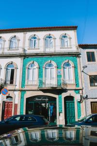 a building on a street with cars parked in front of it at Just Like Home - Casinha da Vila em Caminha in Caminha