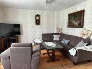 a living room with a couch and a table at Ferienhaus - a90588 in Grevesmühlen