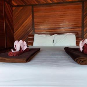 a bed with two towels on top of it at Phi Phi Sand Sea View Resort in Phi Phi Islands