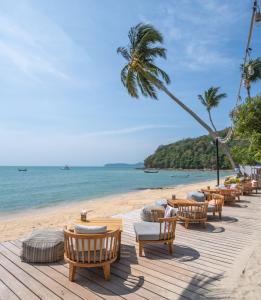 a beach with lounge chairs and the ocean at Bandara Phuket Beach Resort in Panwa Beach
