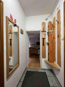 a hallway with a mirror and skateboards on the wall at Cabana Celesta in Predeal