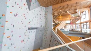 a climbing wall in a gym with a climbing wall at JUFA Hotel Montafon in Bartholomäberg