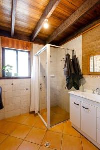 a bathroom with a shower and a sink at Beachy Sleeps! Eco Friendly Family Retreat in Prevelly