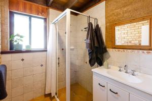 a bathroom with a shower and a sink at Beachy Sleeps! Eco Friendly Family Retreat in Prevelly +36 photos