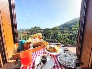 a table with a plate of food on a balcony at La Locanda in Agerola