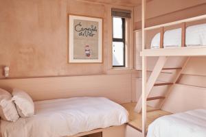 a bedroom with a bunk bed and a bunk ladder at Deus Lodge of Heavy Leisure in Bournemouth