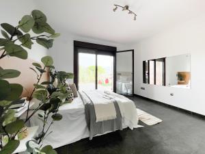 ein Schlafzimmer mit einem Bett und einer Topfpflanze in der Unterkunft CASA VISTA SIERRA in Jaraiz de la Vera
