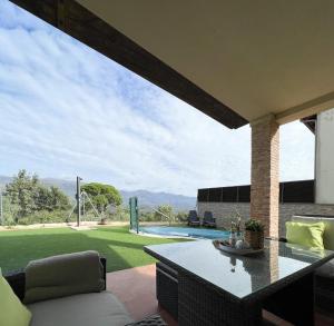 a patio with a table and a view of a yard at CASA VISTA SIERRA in Jaraiz de la Vera