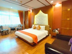 a hotel room with a large bed and a table at Vartika Resovilla Kuiburi Beach Resort and Villas in Kui Buri