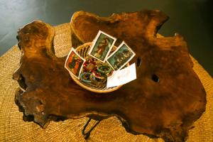 a piece of a tree stump with a basket of cards at Hakuna Woga Inn in Arusha