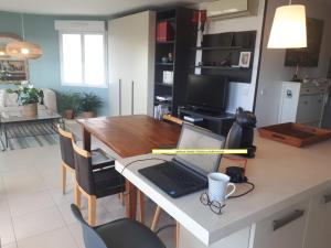 a kitchen with a table with a laptop computer on it at Plein centre de Beaulieu in Beaulieu-sur-Mer +17 photos