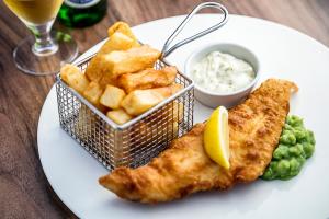 a plate of food with fish and chips and dip at The Wordsworth, Grasmere - The Inn Collection Group in Grasmere
