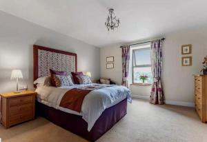 a bedroom with a large bed and a window at Booth House in Elslack