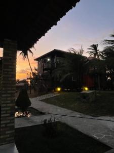 a house with a sunset in the background at Villa Arpoador in Tutóia
