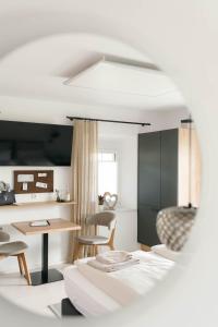 a kitchen and living room with a table and chairs at Pension Blumenwiese in Burgau