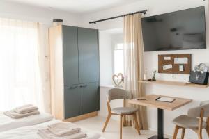 a bedroom with a bed and a desk and a cabinet at Pension Blumenwiese in Burgau