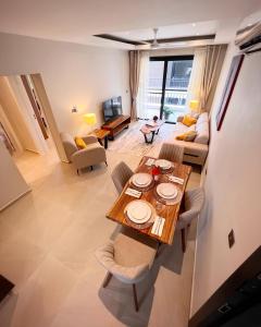 a living room with a table and a couch at Fajara Residence in Fajara