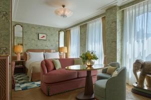 a hotel room with a couch and a bed at Broadwick Soho in London