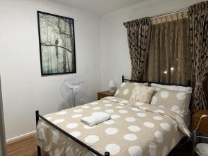 a bedroom with a bed and a fan in it at City Apartment - Free Parking, 3 bedrooms and 2 bathrooms in Adelaide