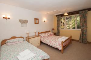 a bedroom with two beds and a window at Makeney Chapel in Duffield