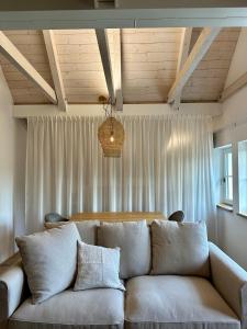 a couch in a living room with a ceiling at Šalet Hrabětice in Janov nad Nisou