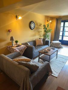 a living room with a couch and a table at Arktouros Hotel in Monodendri