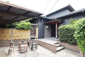 a patio with tables and chairs and a fence at Samp,Inn - Vacation STAY 27372v in Fukuoka
