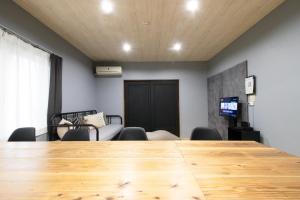 a conference room with a wooden table and chairs at Samp,Inn - Vacation STAY 27372v in Fukuoka